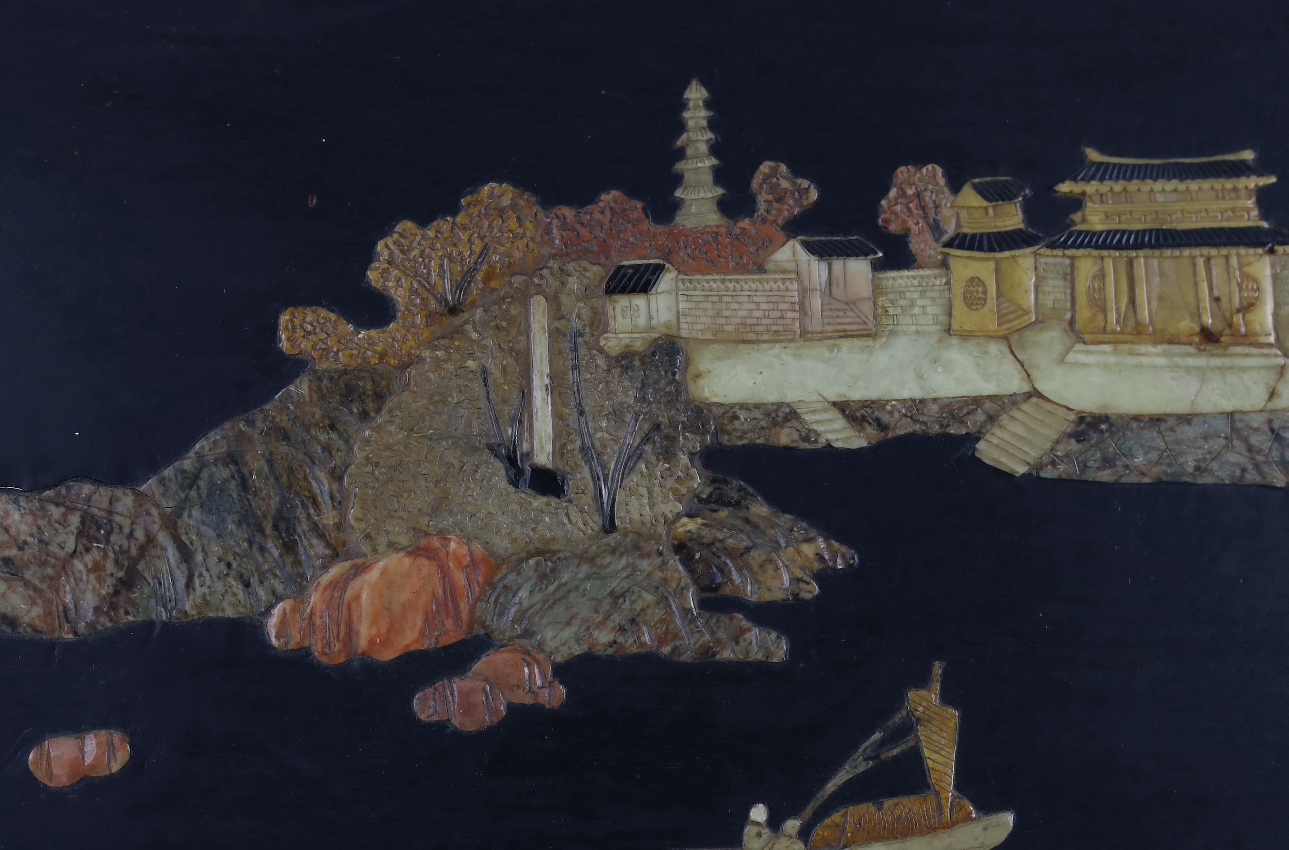 A pair of Chinese soapstone overlaid landscape panels, early 20th century, each panel including frame 33.5cm x 59cm
